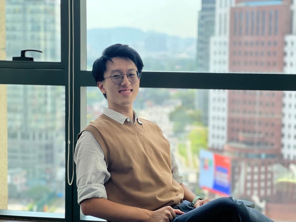 Yi Xiong Wong at Configura sitting on a chair in the office