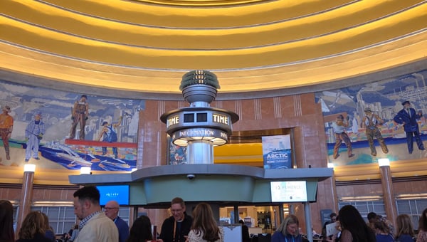 Attendees mingling beneath the mosaic murals of the Union Terminal rotunda