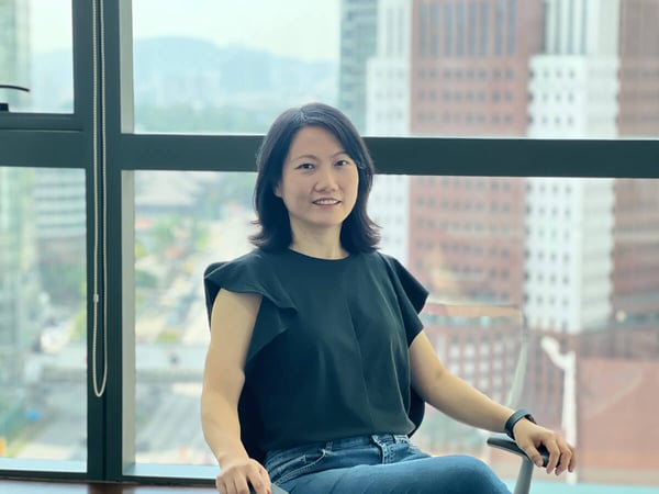 Chiou Hau Tee at Configura sitting on a chair in the office
