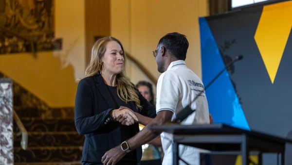 Attendee shaking hands, accepting Configura Award.