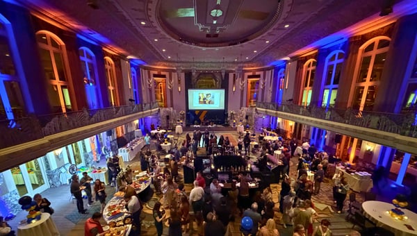The Hall of Mirrors lit in blue and orange for the Time Travelers Ball, full of guests