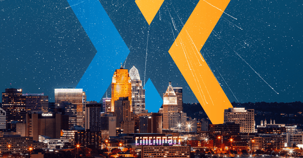 Cincinnati skyline at night with a starry sky, overlaid with a large blue and orange "X" graphic and the text "Cincinnati."